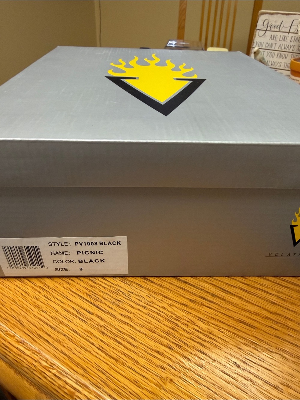 Volatile gray shoe box with yellow flame logo